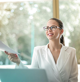 woman in business attire holding a piece of paper