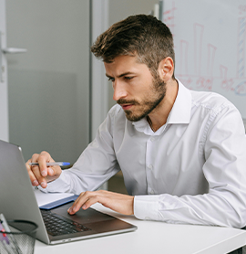 Man in white dress shirt on computer