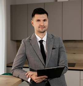 Man in suit holding a clipboard